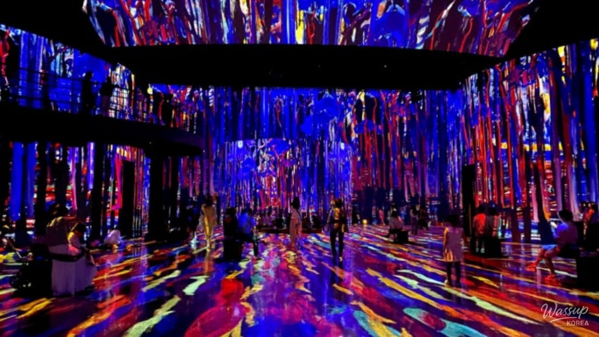Spectacular immersive media art display covering the walls and floor of Théâtre des Lumières
