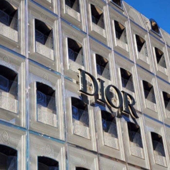 The stunning glass facade of Dior Seongsu reflecting the winter sky in Seoul