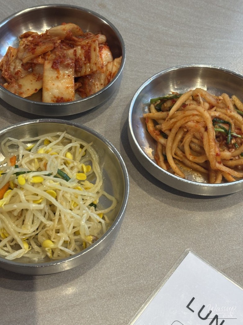 Assorted Korean side dishes including kimchi and bean sprouts at Jogabi