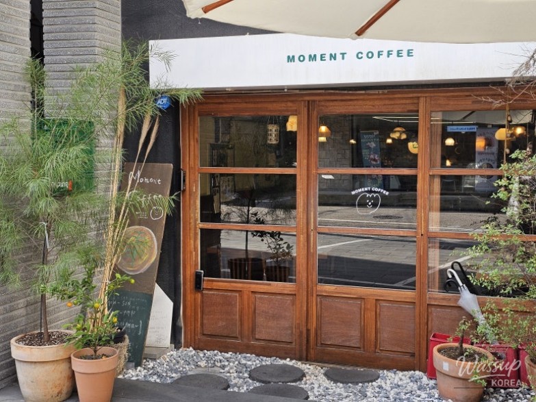 Cozy wooden exterior of Moment Coffee 2nd Branch in Hongdae resembling a Japanese village cafe