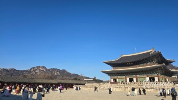 A clear winter sky over the majestic traditional architecture of Gyeongbokgung Palace on New Year's Day
