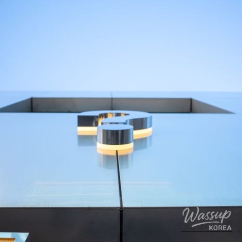 A variety of colorful donuts including strawberry chocolate French cruller and glazed options