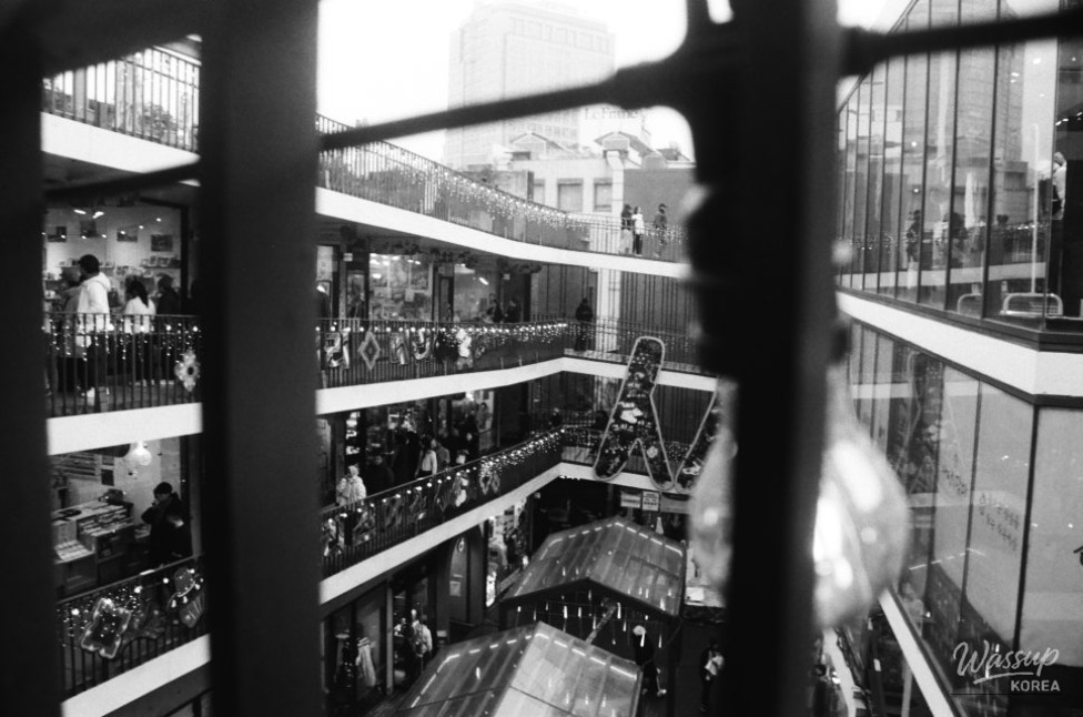 A collection of acoustic guitars displayed at Nakwon Instrument Arcade in black and white