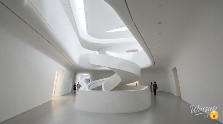 Close-up of the unique aluminum panels on the DDP exterior reflecting urban light