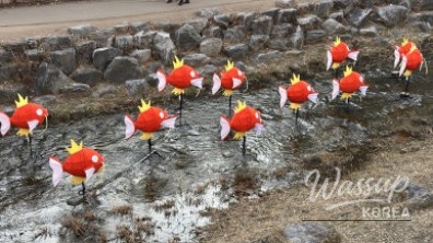King Carp and character displays during daytime at Cheonggyecheon