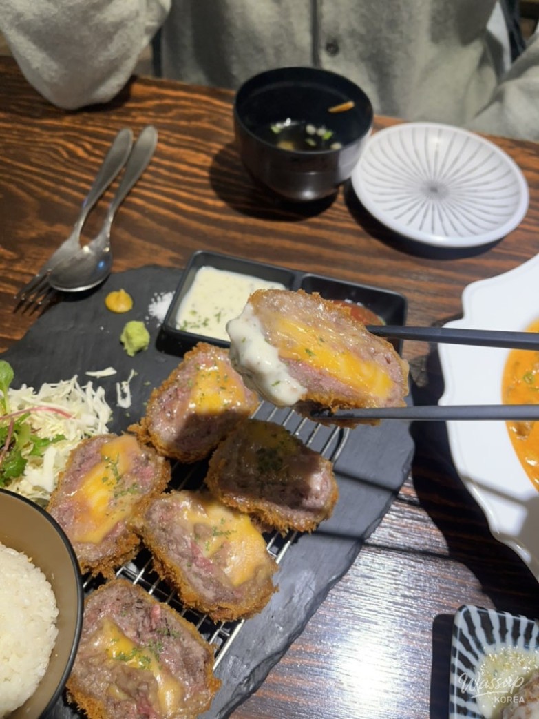 Side salad and sauce setup accompanying katsu dishes