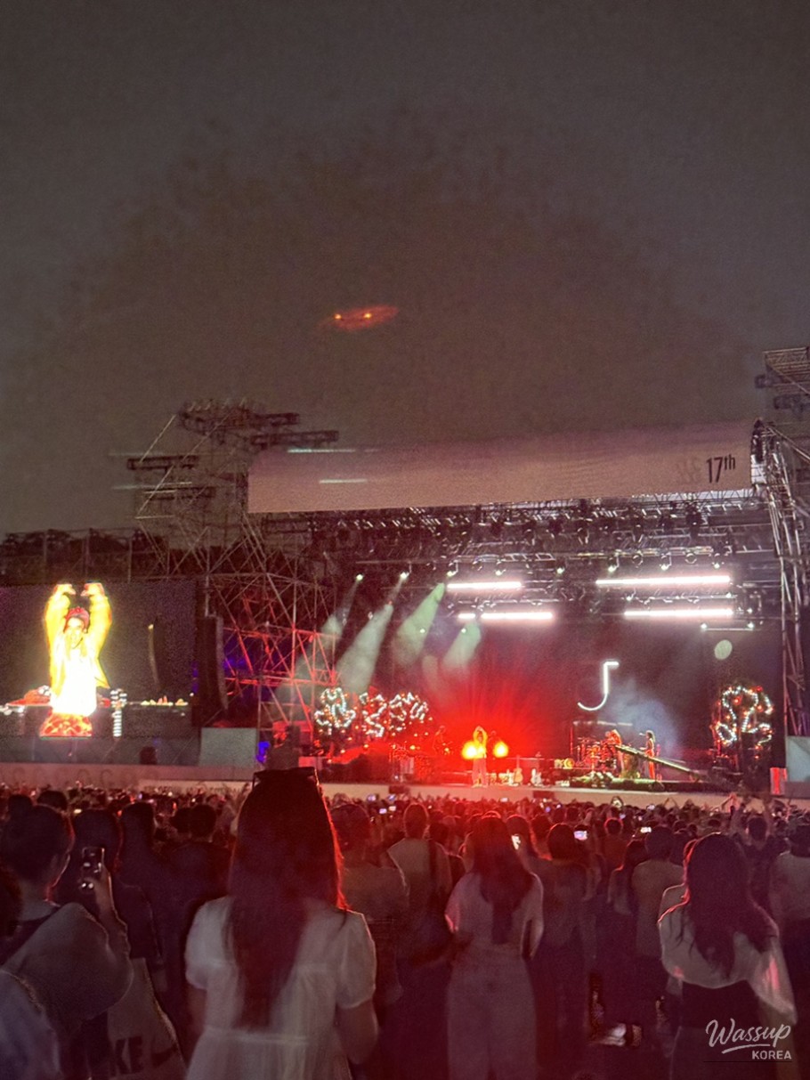 Intense concert night scene with crowd energy rising near the front of the stage