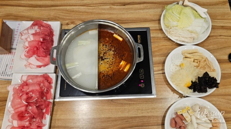 Interior overview showing multiple tables at Daehong Shabu Shabu