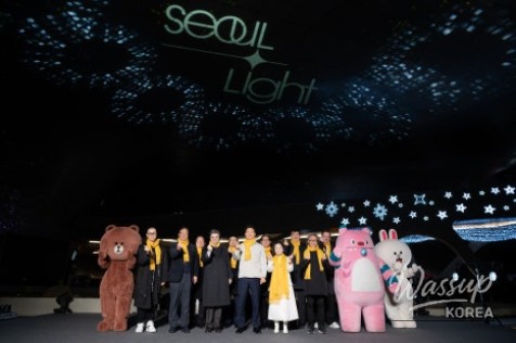 Visitors walking through illuminated DDP architecture at night