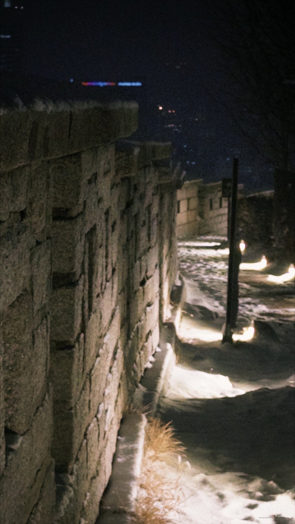 Snow falling near Gwanghwamun at night