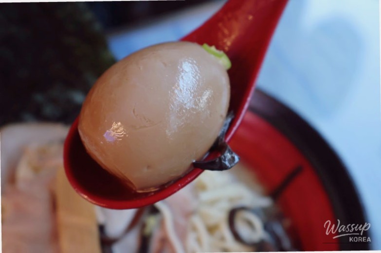 Close-up of chewy ramen noodles and tender chashu at Uchu Jin Ramen