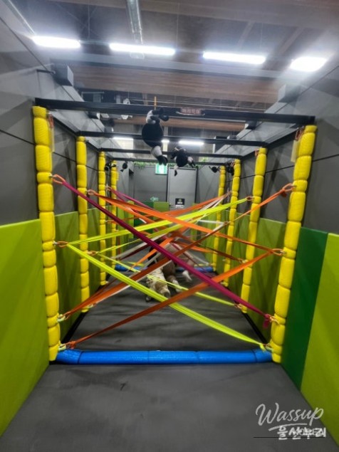 Children calmly observing and resting between play activities in the maze