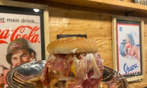 Handmade burger meal enjoyed casually in a cozy Jeju restaurant suitable for solo or group dining