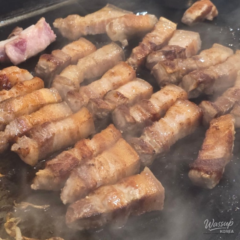 Close-up of cooked Jeju black pork showing juicy texture and balanced fat