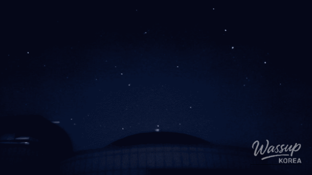 Snow-covered Windy Hill on Maebongsan with wind turbines beneath a vivid Milky Way