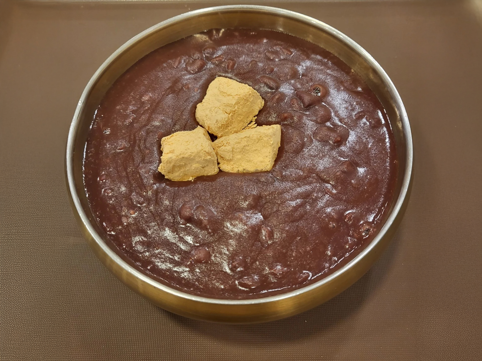 A bowl of traditional black sesame bingsu topped with domestic red beans at Maru Patbingsu