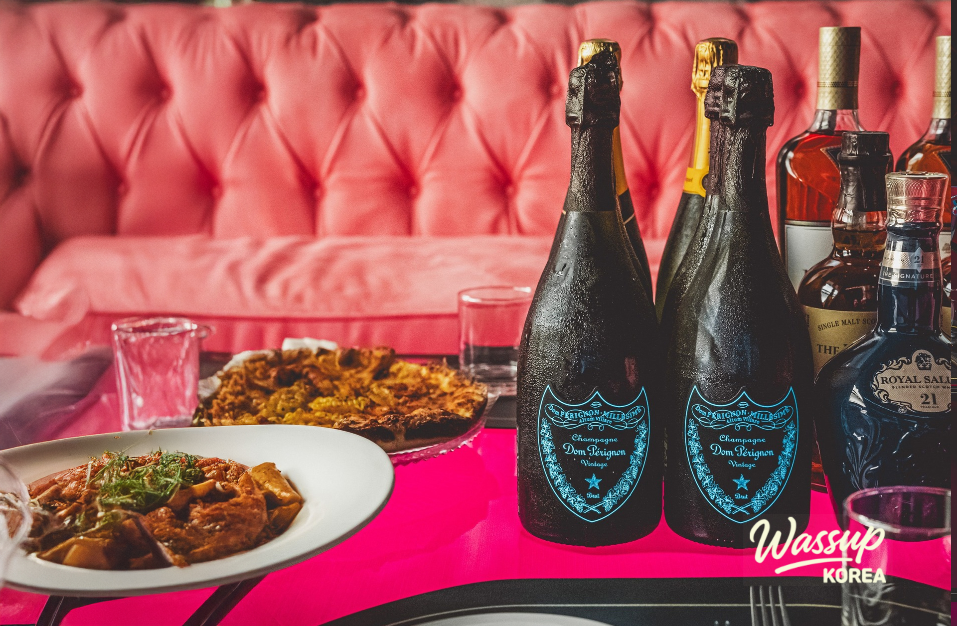 Artistic wall mural and stylish sofa arrangement in the Poseidon Room at Bacchus