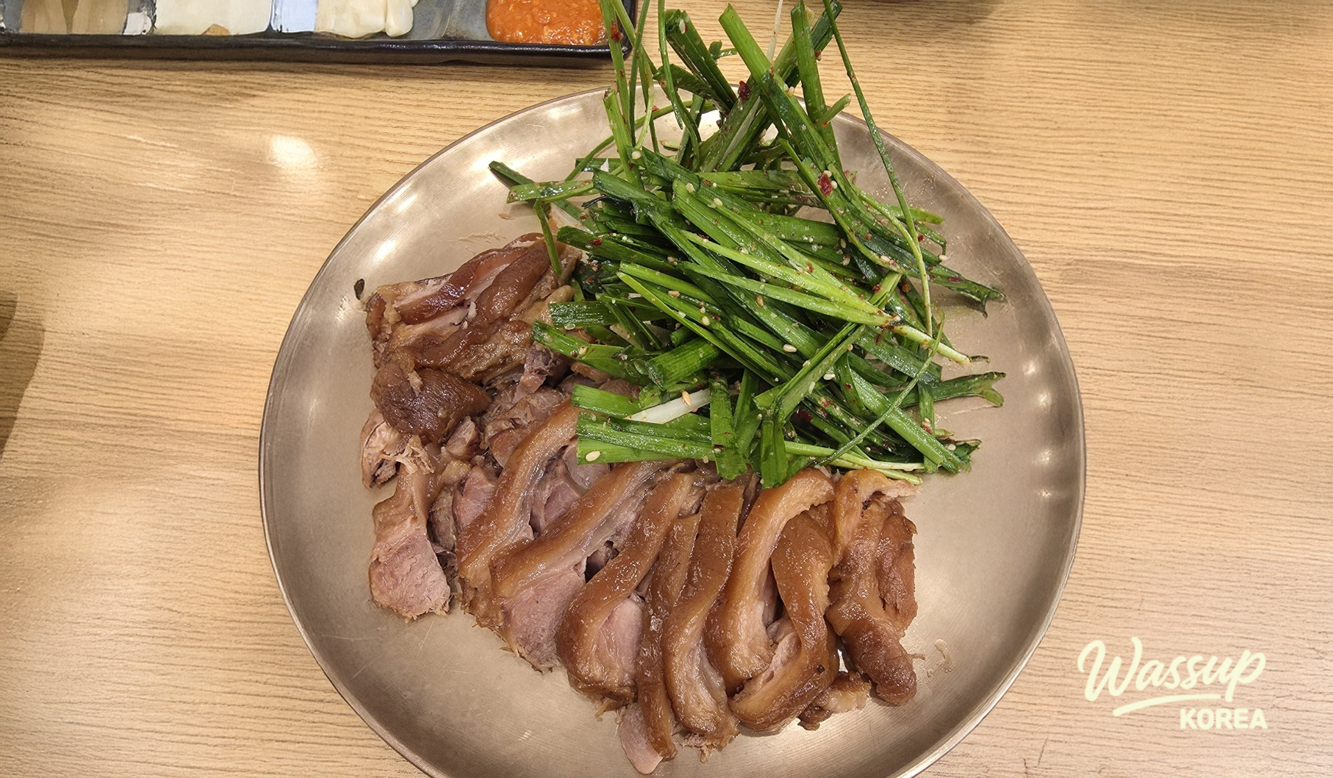 Tender boiled pork slices served with a seasoned chive salad