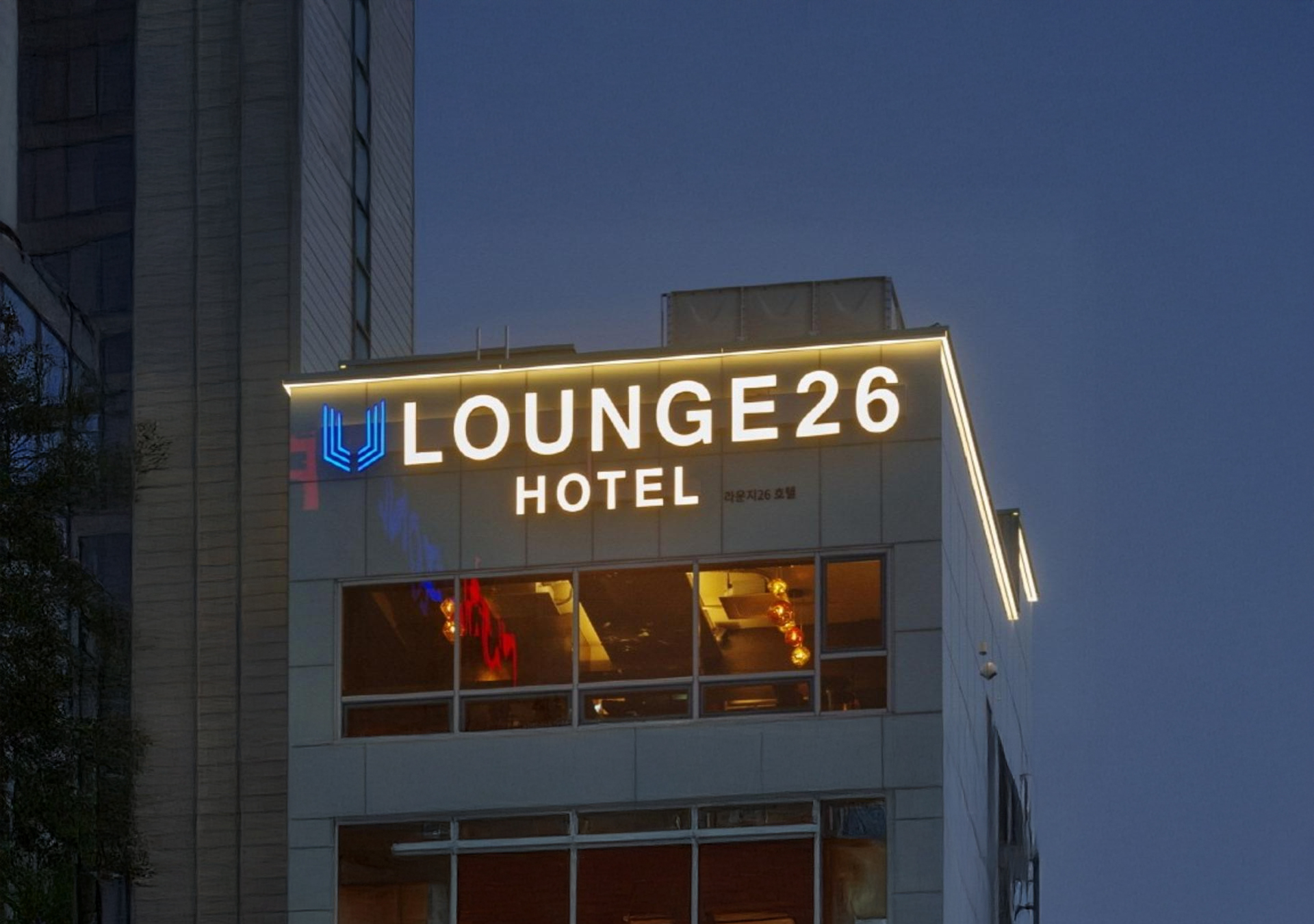 Hotel entrance and nearby paid parking next to Lounge 26 Hotel