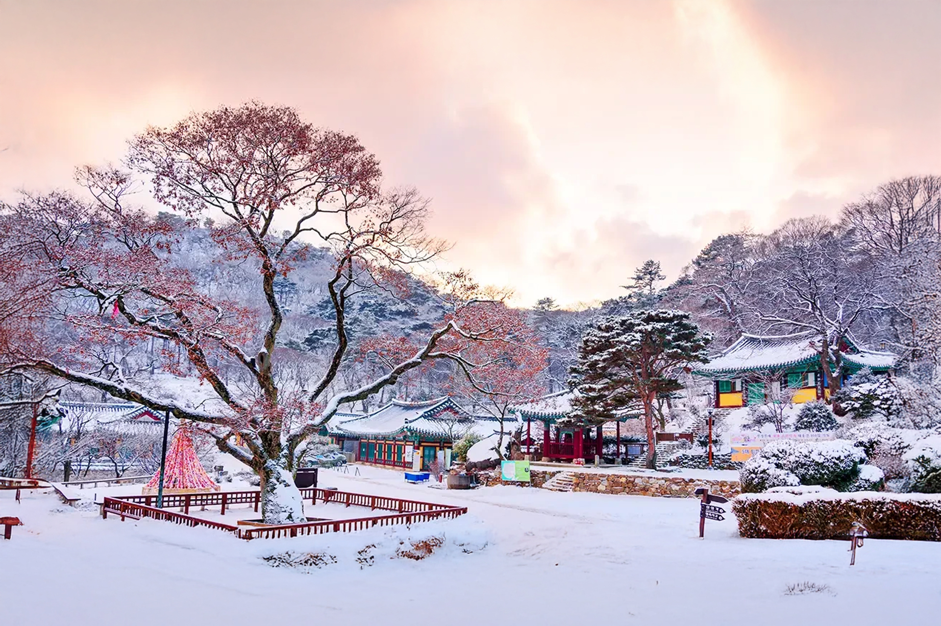 Jeondeungsa Temple covered in white snow with traditional eaves highlighting the winter landscape