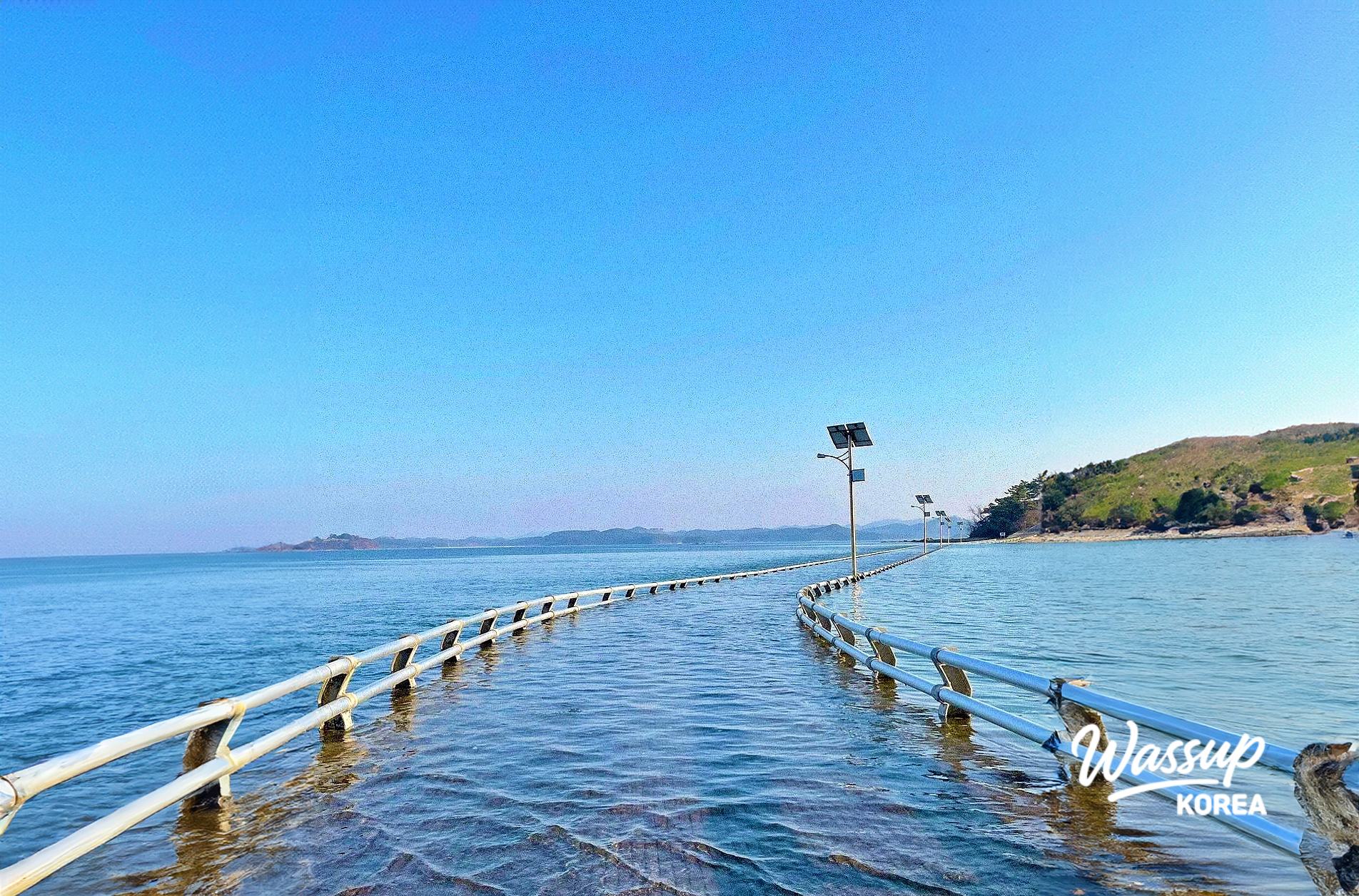 Scenic coastal deck path stretching over the blue waters of Garoim Bay at Ungdo Island