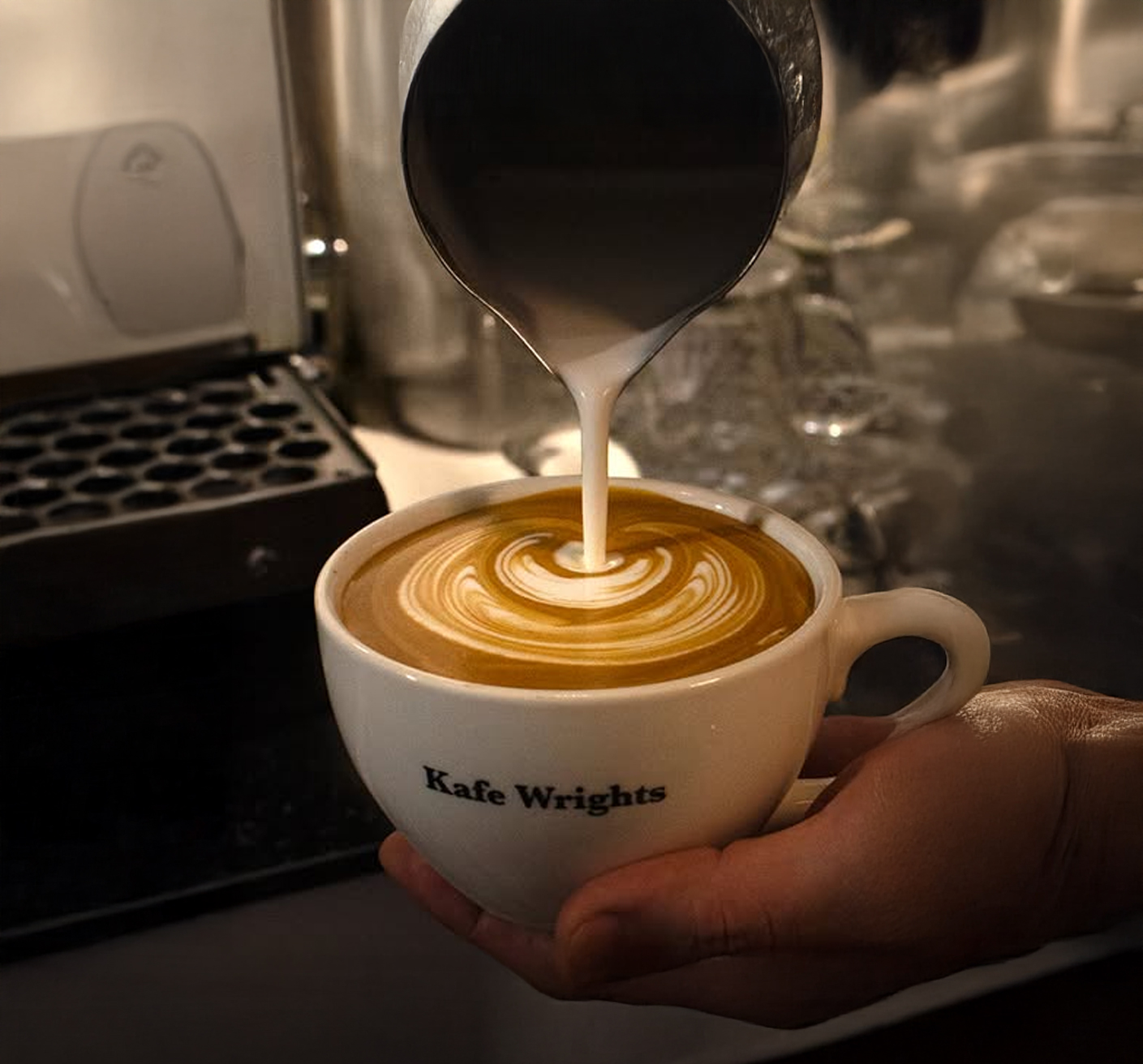 The modern white exterior and entrance of Kcafe Wrights near Kondae Station