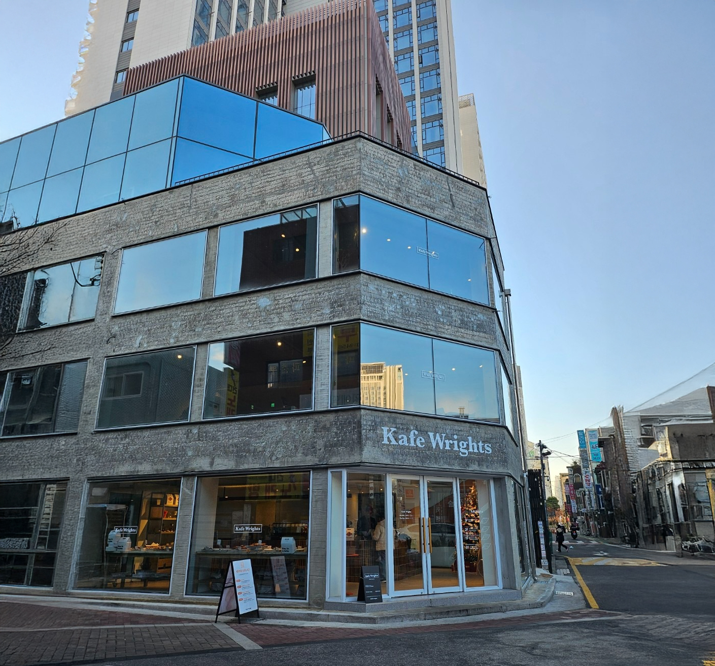 Cozy indoor seating area of Kcafe Wrights with modern white decor and warm lighting
