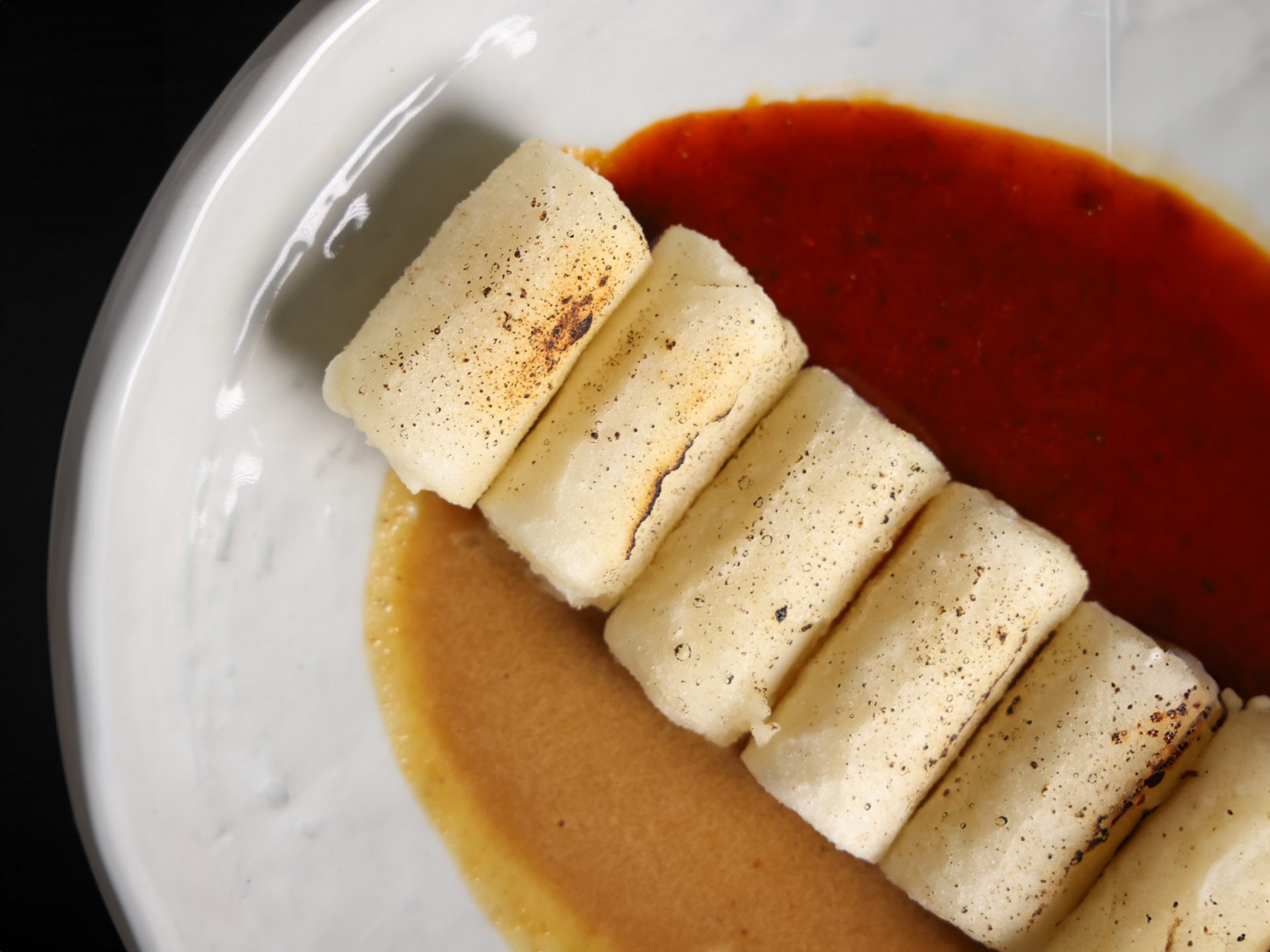 Side dishes including squid sundae and crispy potato pancakes