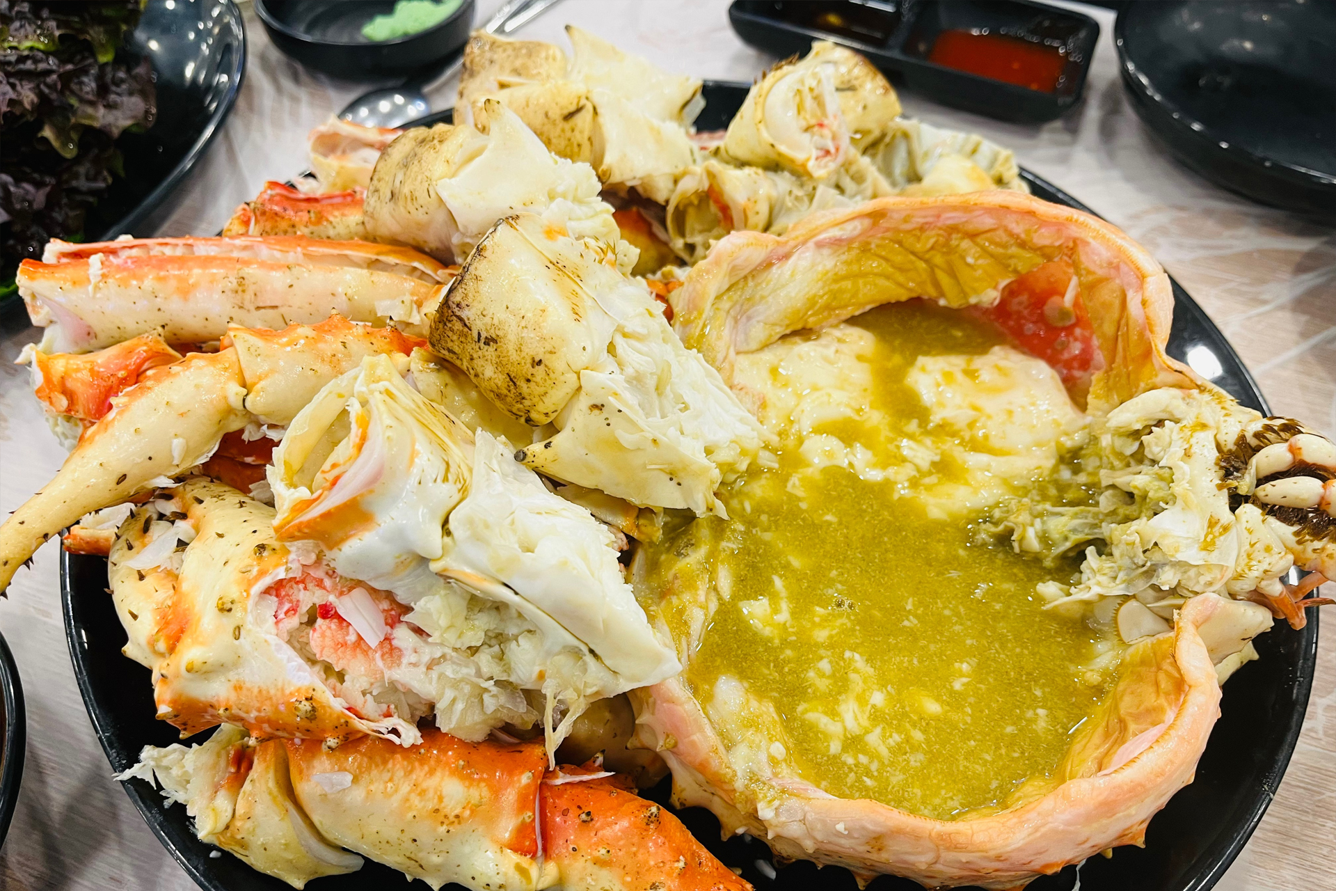 A massive and fresh A-grade king crab being held up at Noryangjin Fish Market