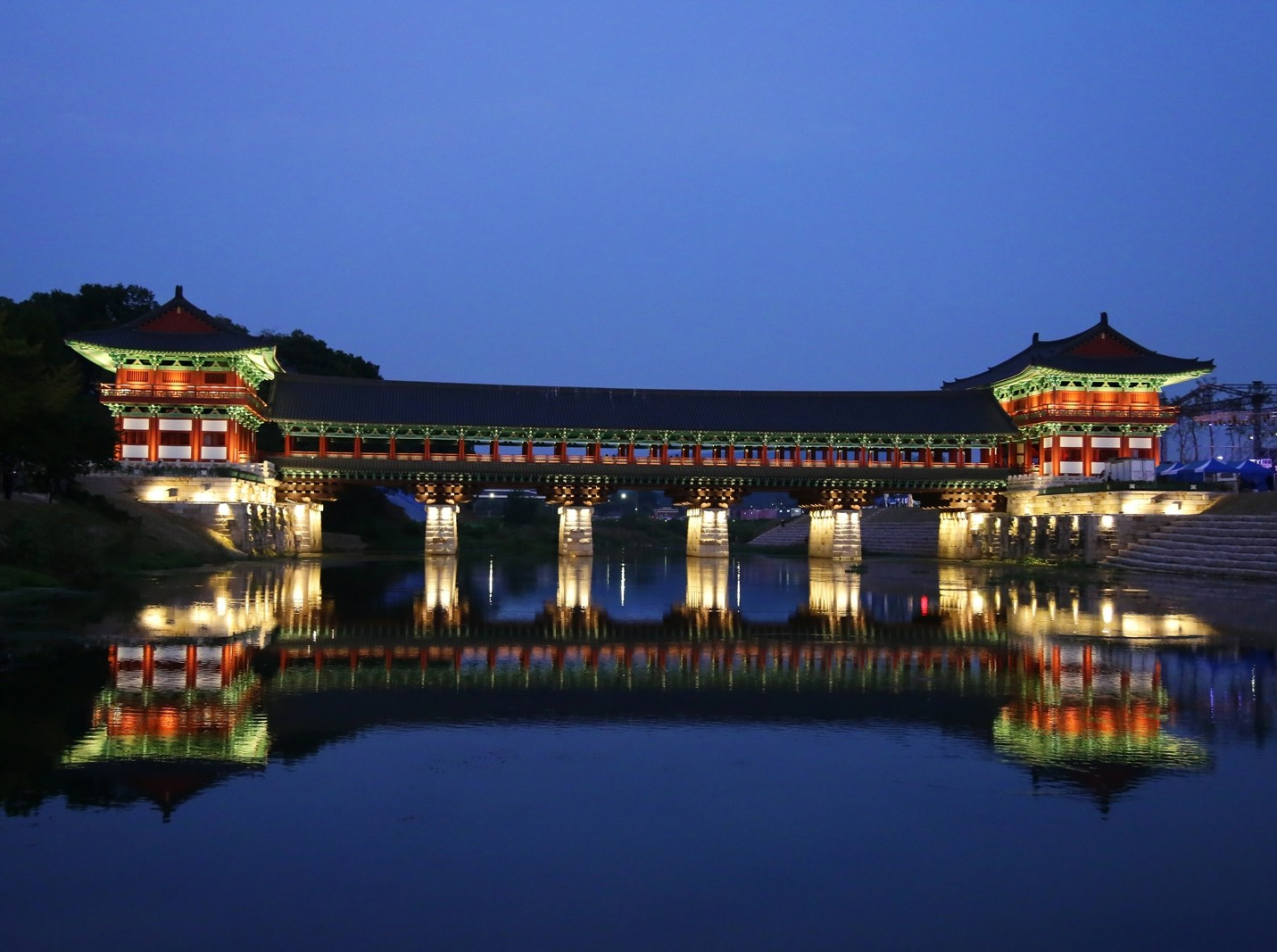 Illuminated traditional Hanok structures reflecting the golden glow of Gyeongju at night