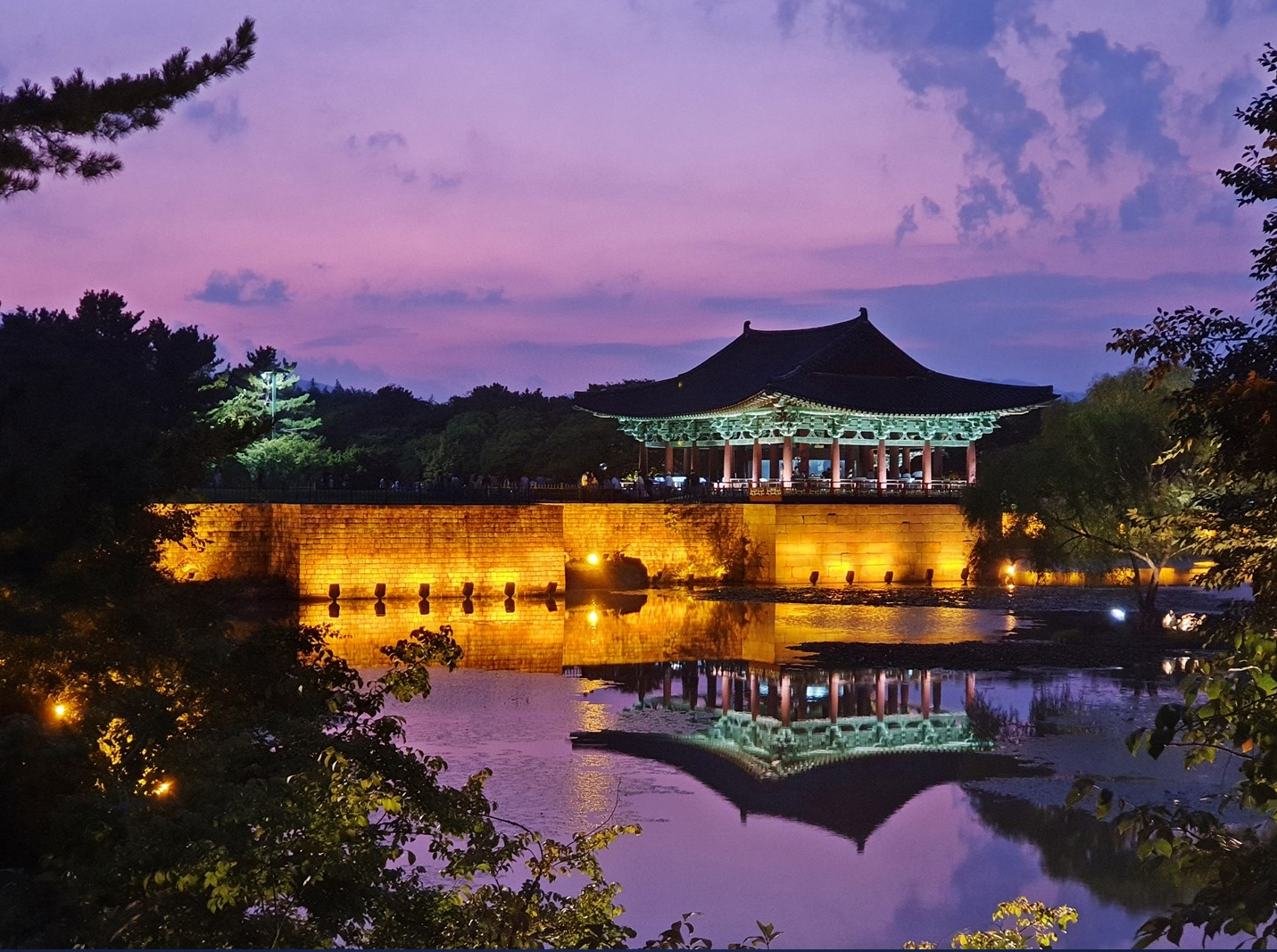 Traditional architectural details of Woljeonggyo Bridge glowing against the nighttime sky