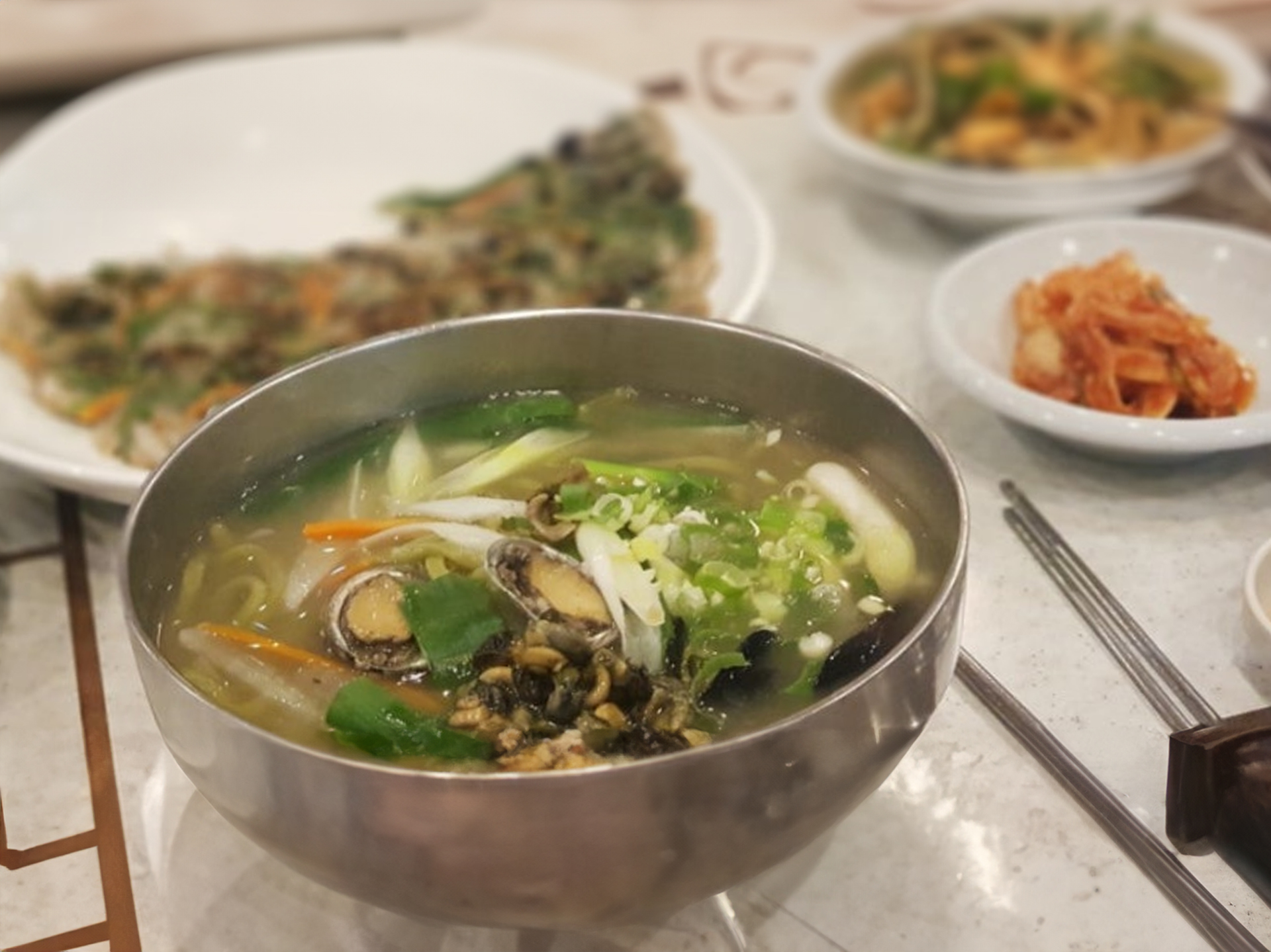 Spacious dining hall interior of a Jeju seafood noodle restaurant