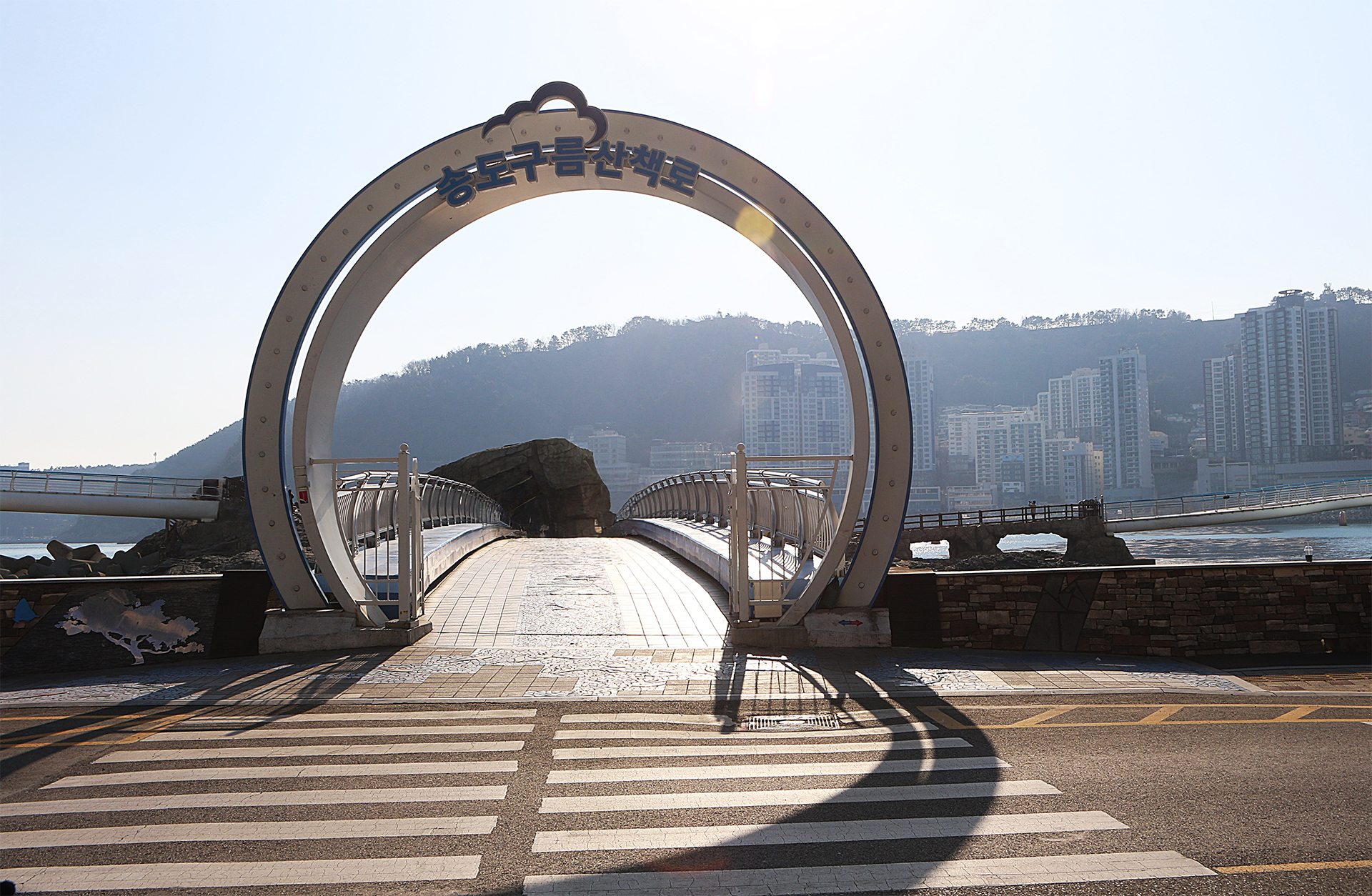 Information board and surrounding scenery at Songdo Coastal Walkway