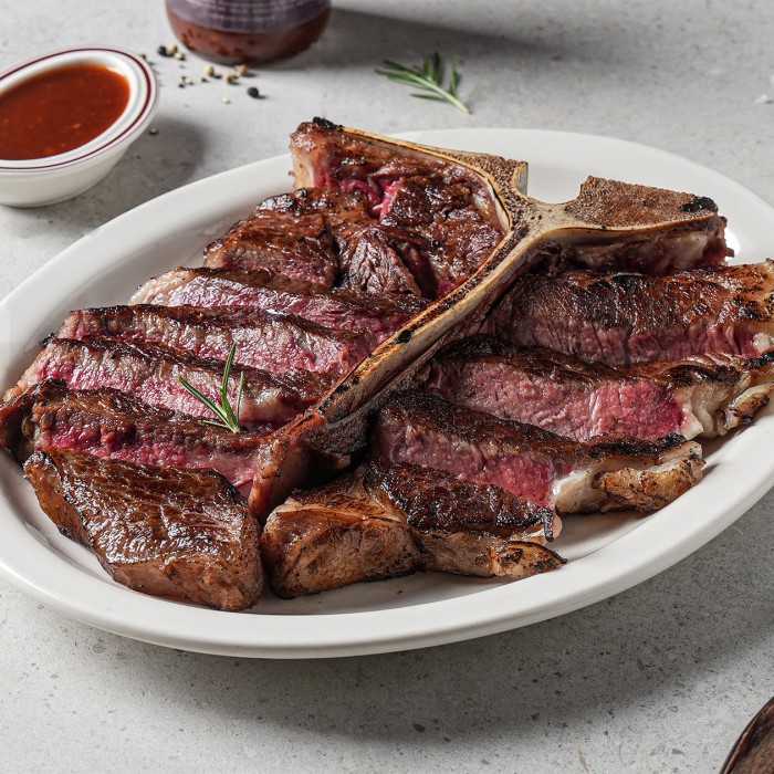 A perfectly grilled premium steak served with savory side dishes at NOPS Seoul Station