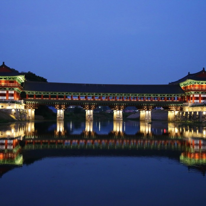 Illuminated traditional Hanok structures reflecting the golden glow of Gyeongju at night